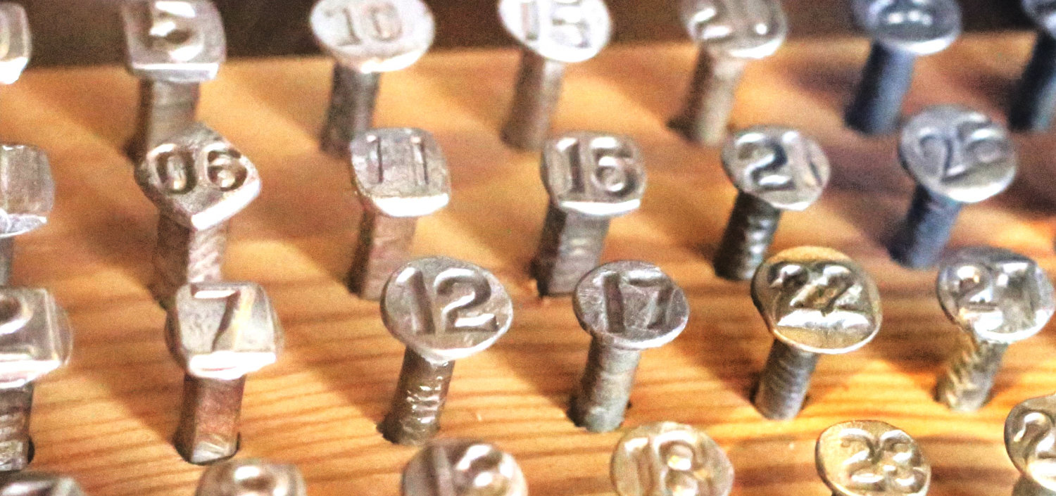 A collection of railroad tie nails embossed with the year of manufacture courtesy of E.M. and Kathleen Bradshaw.